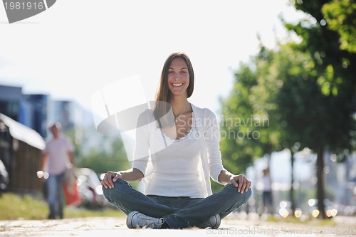 Image of yoga at sunny street
