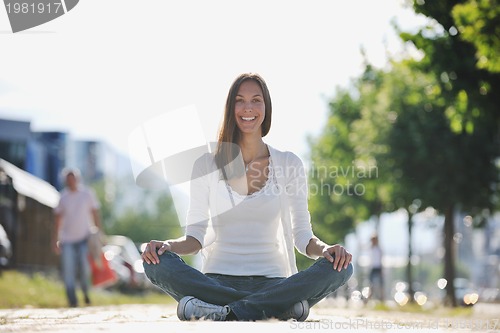 Image of yoga at sunny street