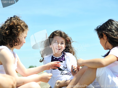 Image of happy child group playing  on beach