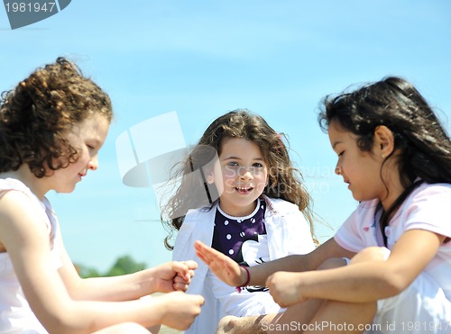 Image of happy child group playing  on beach