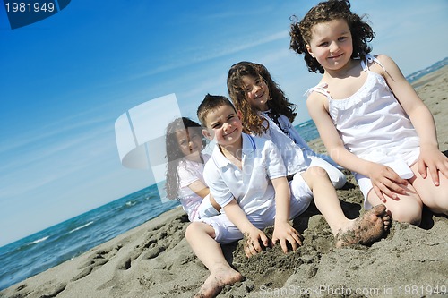Image of happy child group playing  on beach