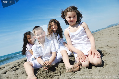 Image of happy child group playing  on beach