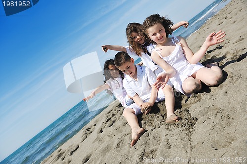 Image of happy child group playing  on beach