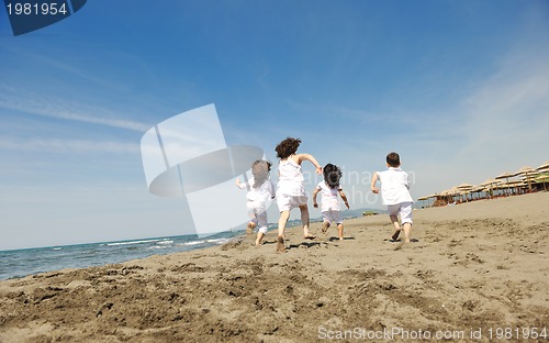 Image of happy child group playing  on beach