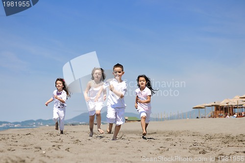 Image of happy child group playing  on beach