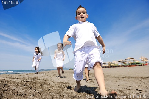 Image of happy child group playing  on beach