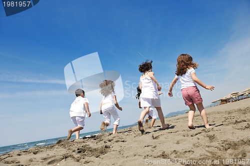 Image of happy child group playing  on beach