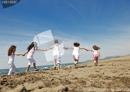 Image of happy child group playing  on beach