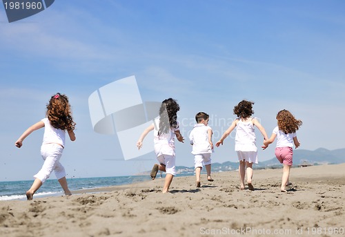 Image of happy child group playing  on beach