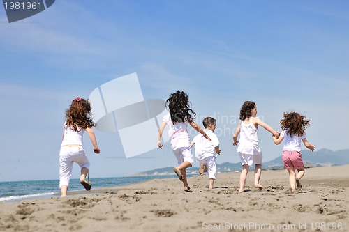 Image of happy child group playing  on beach