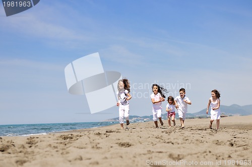Image of happy child group playing  on beach