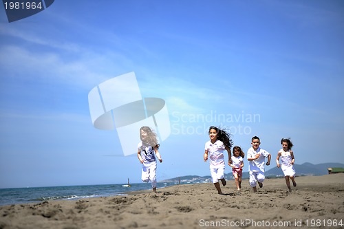 Image of happy child group playing  on beach