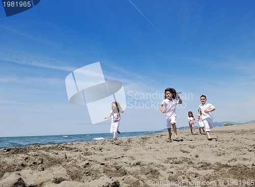 Image of happy child group playing  on beach