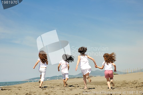 Image of happy child group playing  on beach