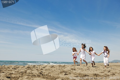 Image of happy child group playing  on beach