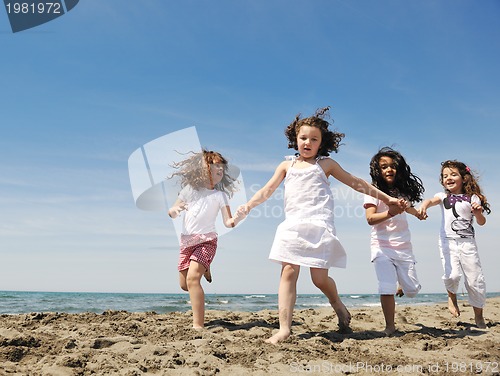 Image of happy child group playing  on beach