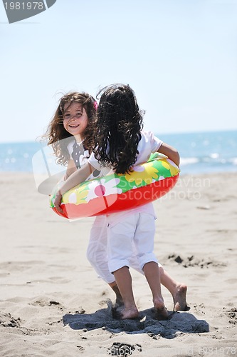 Image of happy child group playing  on beach