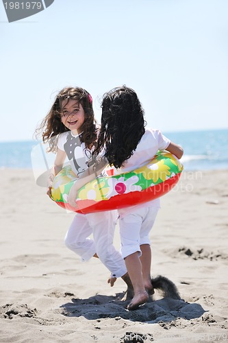 Image of happy child group playing  on beach