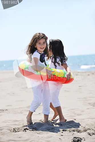 Image of happy child group playing  on beach