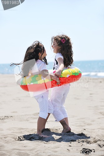 Image of happy child group playing  on beach