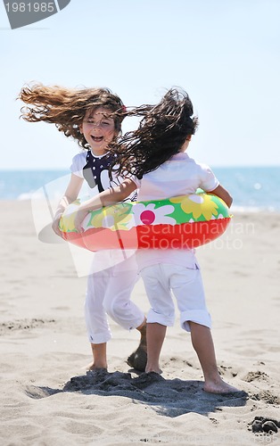 Image of happy child group playing  on beach