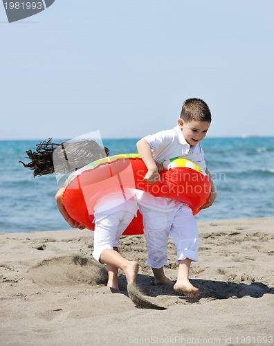 Image of happy child group playing  on beach