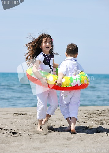 Image of happy child group playing  on beach