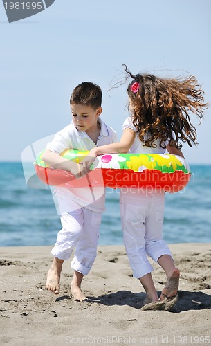 Image of happy child group playing  on beach