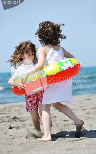 Image of happy child group playing  on beach