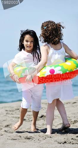Image of happy child group playing  on beach