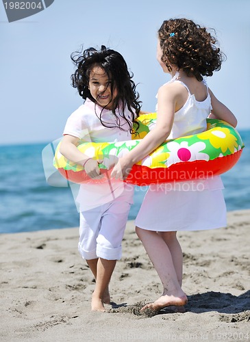 Image of happy child group playing  on beach