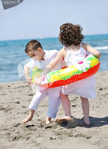Image of happy child group playing  on beach
