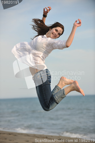 Image of happy young couple have fun on beach