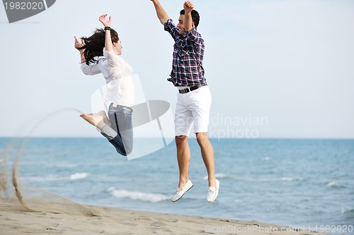 Image of happy young couple have fun on beach