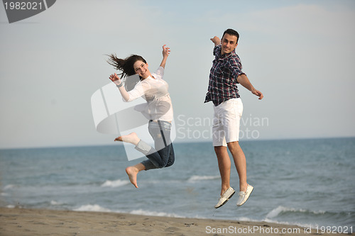 Image of happy young couple have fun on beach