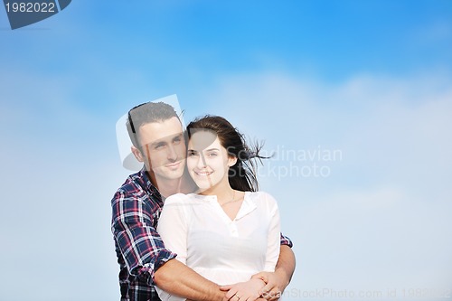 Image of happy young couple have fun on beach