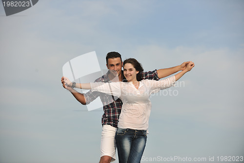 Image of happy young couple have fun on beach