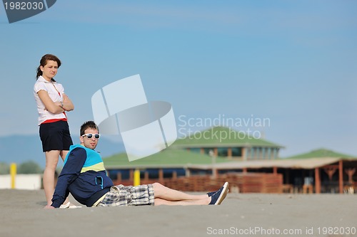 Image of happy young couple have fun on beach