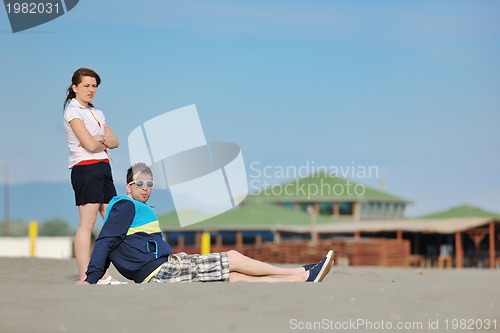 Image of happy young couple have fun on beach