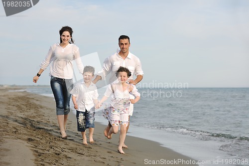 Image of happy young family have fun on beach