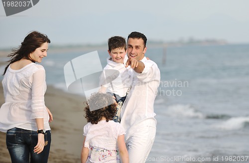 Image of happy young family have fun on beach