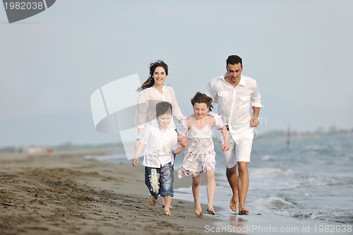 Image of happy young family have fun on beach