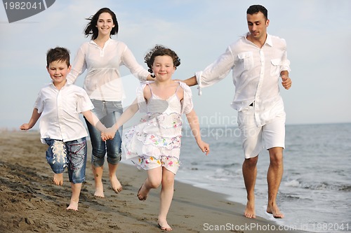 Image of happy young family have fun on beach