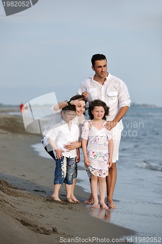 Image of happy young family have fun on beach