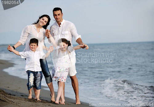 Image of happy young family have fun on beach