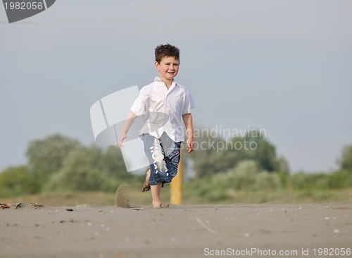 Image of little boy running on beach