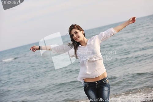 Image of young woman enjoy on beach