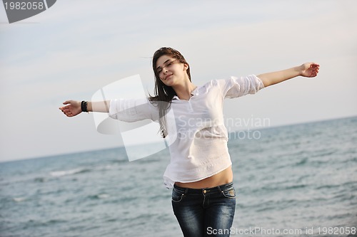 Image of young woman enjoy on beach