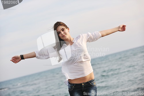 Image of young woman enjoy on beach