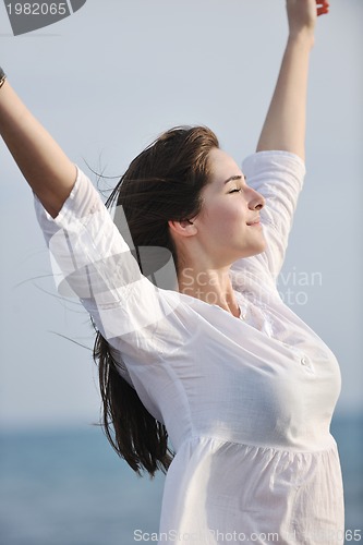 Image of young woman enjoy on beach